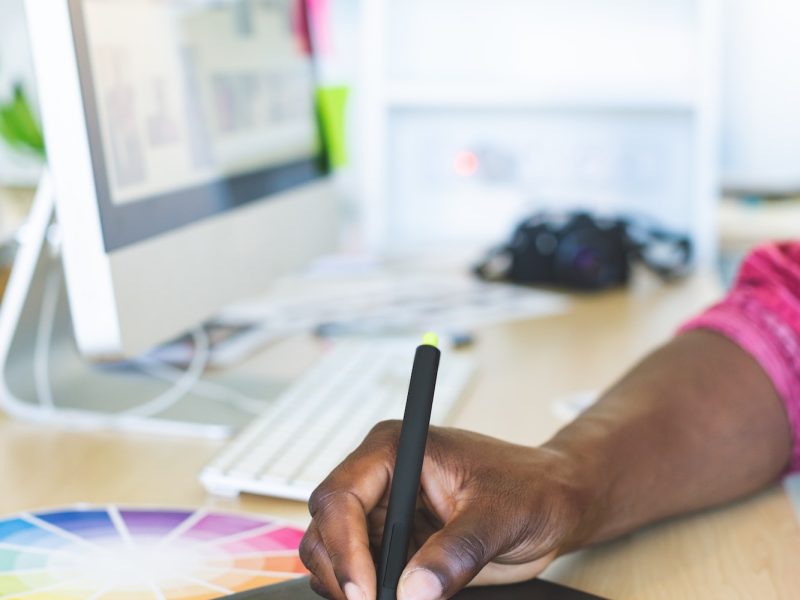 close-up-of-young-african-american-graphic-designer-working-on-graphic-tablet-at-desk-in-office.jpg